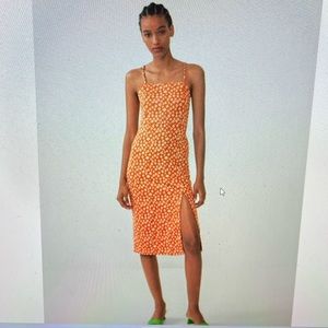 Fitted orange flower midi dress with slit. Size M.